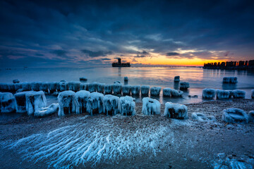 Fototapeta na wymiar Amazing landscape of frozen beach of baltic Sea in Babie Doly at sunrise. Gdynia, Poland