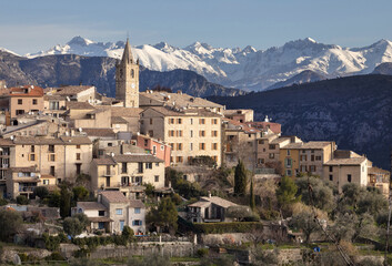 Fototapeta na wymiar The ancient village of Le Broc in the Maritime Alpes in France with snow on the mountains