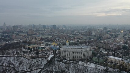Europe, Kiev, Ukraine - February 2021: aerial view of the Podil area, St. Andrew's Church, Kontraktova Square and Kiev. Old residential buildings overlooking the city.
