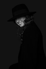 Fashion photo of smiling young woman in hat. Girl posing. Studio photo. Perfect Makeup. Black and white view.