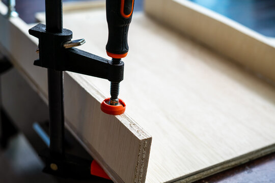 Wood working. Fine quality hardwood lumber, ready for use. f-clamp holding on lumber.