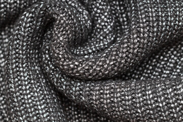 black and silver knitted fabric with folds texture background