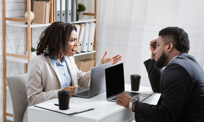 Angry African American woman having fight with her collague at company office, copy space