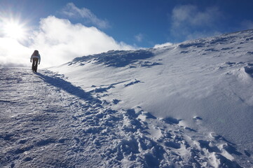 Single trail of footprints in deep snow, mountain area