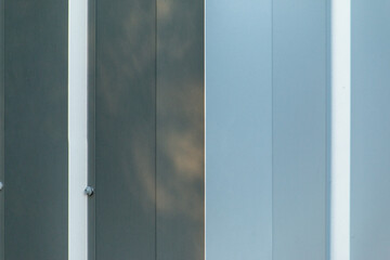 corner of shiny metal building wall paneling