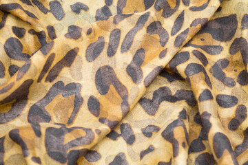 Orange and brown leopard spots pattern printed  on textile texture background