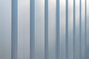 Gray-blue metal panel striped wall receding into the distance