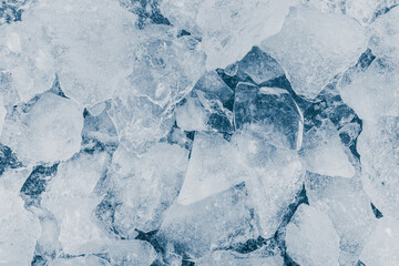 Ice pieces texture background. Crushed ice blue toned pattern.