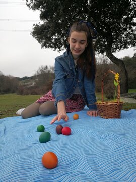 chica,jugando con huevos de pascua en el parque