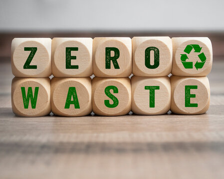 Cubes, dice or blocks with zero waste and recycling logo on wooden background