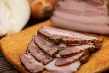 Smoked brisket sliced on a wooden chopping board.