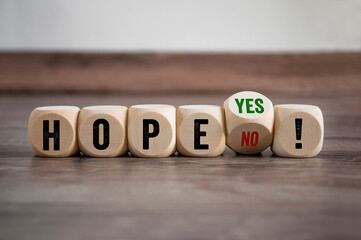 Cubes, dice or blocks with hope yes and no on wooden background