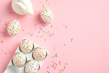 Creative layout with colorful Easter eggs and bunny on pink background. Happy Easter banner mockup. Minimal style. Flat lay, top view.