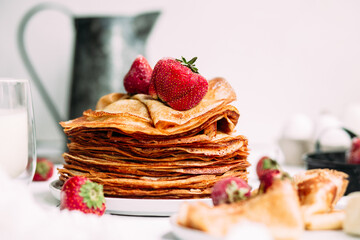 Thin pancakes with milk in a plate. crepes 