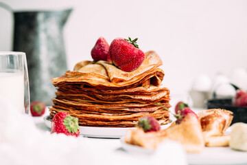 Thin pancakes with milk in a plate. crepes 