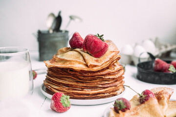Thin pancakes with milk in a plate. crepes 