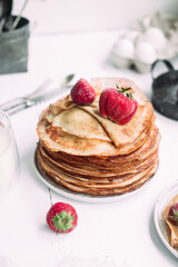 Thin pancakes with milk in a plate. crepes 