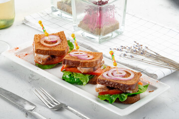 Catering Chicken Sandwiches on a white plate on table