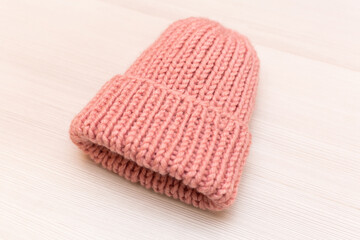 Pink women's wool hat on white background