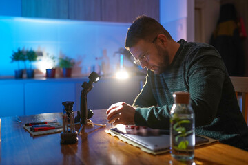 Technician holding screwdriver and repairing laptop at home