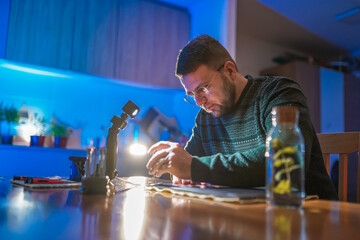 Technician with eyeglasses repairing laptop at home
