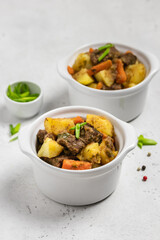 Comfort winter food, roast and potatoes in pots. Copy space.