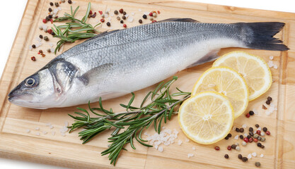 Fresh uncooked pike perch with lemon, rosemary and spice on wooden board on white background