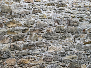 Large stone wall in light brown shades.