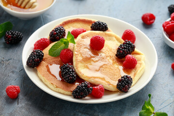 Morning breakfast Pancakes with fresh berry and honey. Healthy food