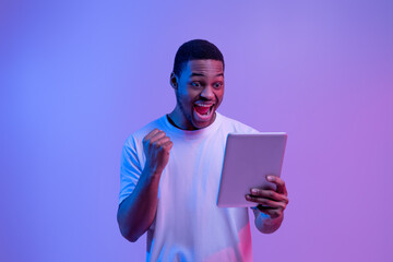 Online Win. Joyful African American Guy Celebrating Success With Digital Tablet,