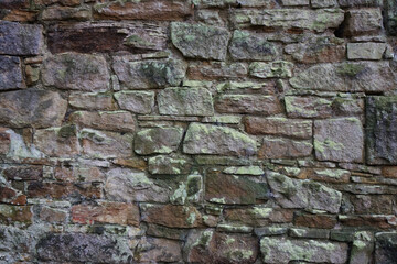 Old mixed size stones building wall close up