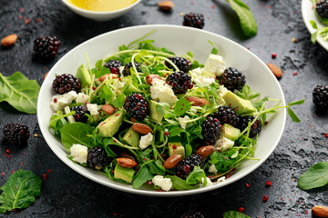 Blackberry salad with greens, almond nuts, feta, avocado and feta cheese
