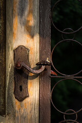 metalowa klamka w starej drewnianej furtce