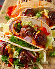 Meat free beetroot and pea protein meatballs taco wraps with avocado guacamole, sweet chilli sauce...