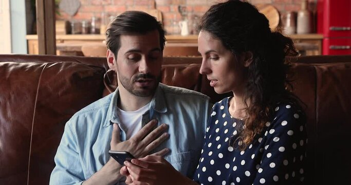 Married couple sort their relations. Wife check phone of husband makes claim, he justifies himself for sms in social network or call history. Distrust, jealousy, reveal betrayal in messages concept