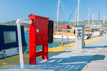 Red safety hydrant station at marina. Fire safety concept.