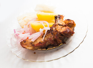 dish of fried pork ribs, rice, potatoes, sweet potato and pickled onions