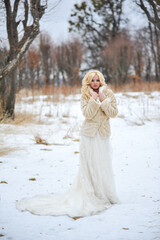 Beautiful bride near old castle on winter day wedding 