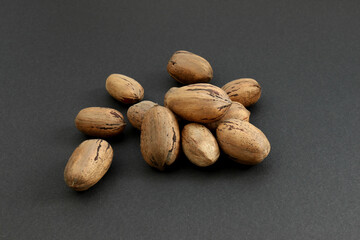 a few close up pecans on the black background