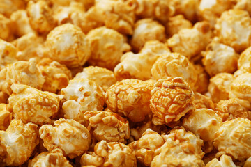 Caramel popcorn close-up as a background, full-screen texture.
