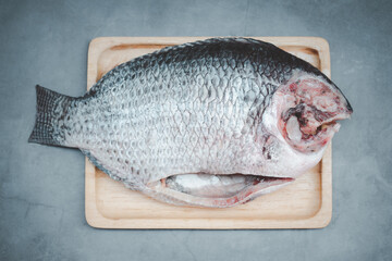 Tilapia fish on wooden tray ready to cooking
