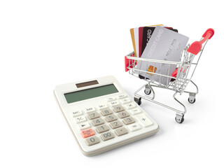 Mini shopping cart and credit cards is in the shopping cart with calculator for present about spend money by credit card concept and e-commerce, shopping, business, finance