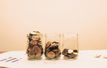 business concept for financial and banking with coin stack and coins in glass to saving and investment.