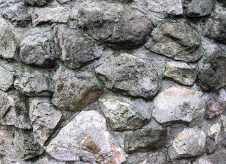 Large boulders embedded in the wall. Texture with embossed stones.