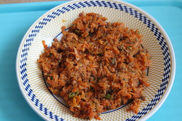 Top closeup view of a homemade dish made from carrot and vegetables.