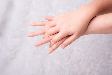 Woman's hand measuring invisible items. Isolated on white