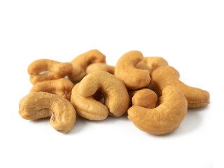 Tasty Roasted Cashew nuts isolated on white background. Natural fruit snack for healthy food concept.