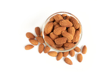 Organic almonds in glass bowl and heap almonds isolated top view on white background for almond nuts can improve health concept.