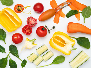 Assorted vegetables of different colors on a white table.