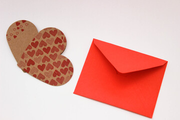 Concept photo for a heart-shaped paper love messaging in a red envelope or for chat sites. top view.